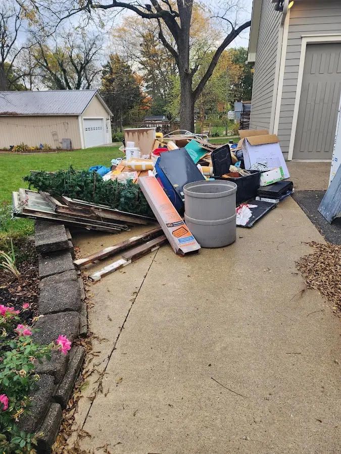Dumpster being loaded with debris for Commercial Dumpster Rental in Long Hill